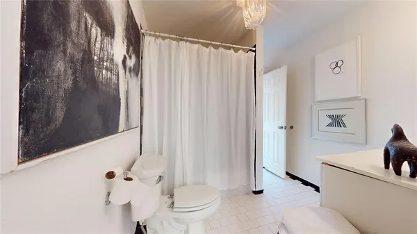 a bathroom with a shower and a toilet