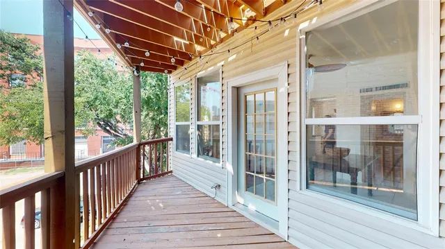 a view of a porch with wooden floor and furniture