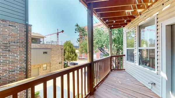 a view of a porch with wooden floor and iron stairs