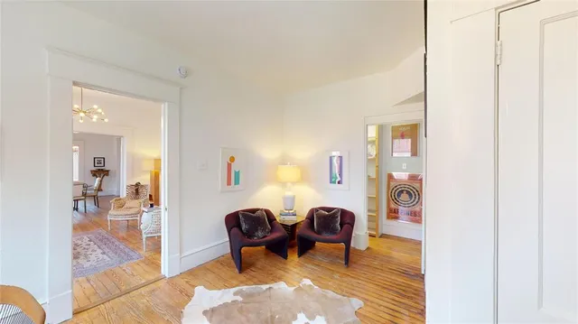 a living room with furniture a lamp next to a window