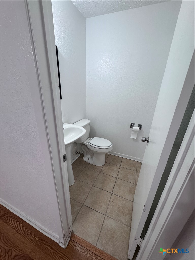 1301 North 10th Street Temple, TX 76501 - Photo 16 of 25 a bathroom with a sink and a toilet