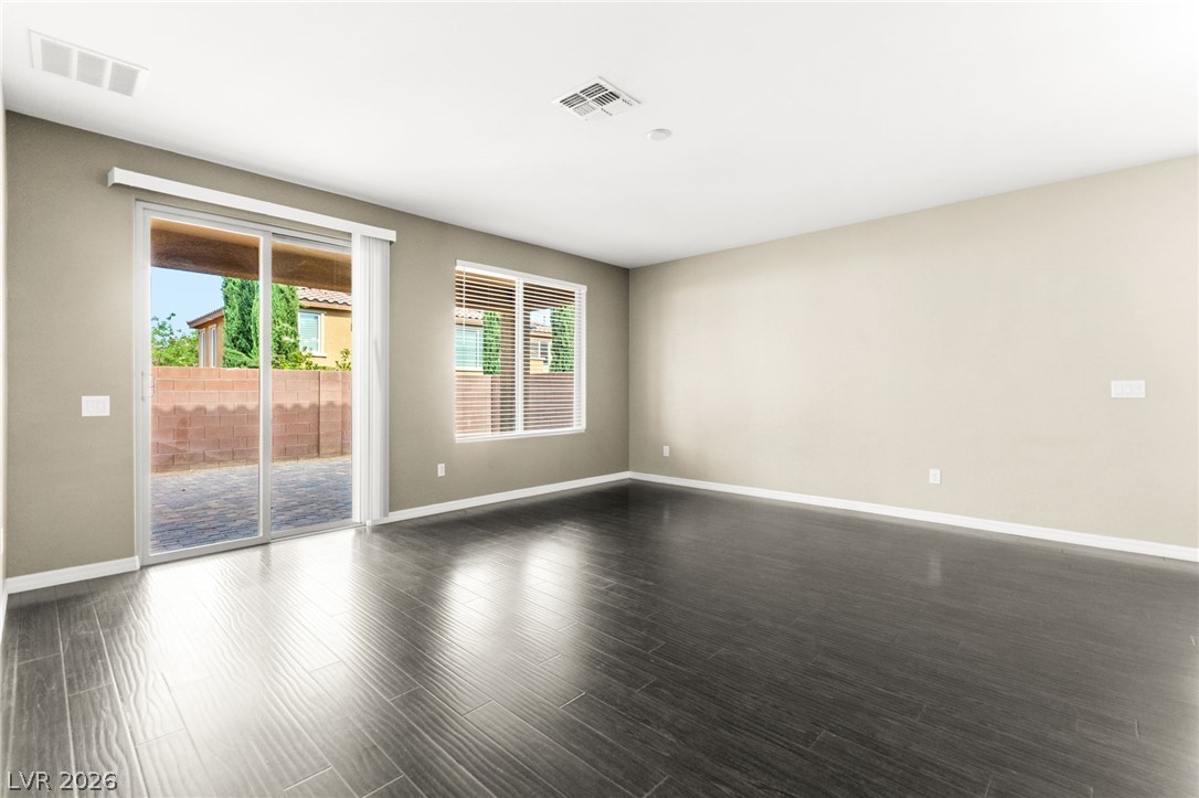 11048 Prairie Grove Road Las Vegas, NV 89179 - Photo 10 of 75 Floor-to-ceiling glass sliding doors open to an inviting outdoor space.