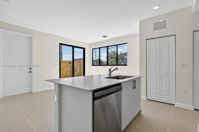 a kitchen with a sink and cabinets