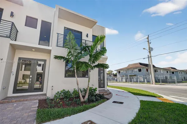 a front view of house with yard and green space
