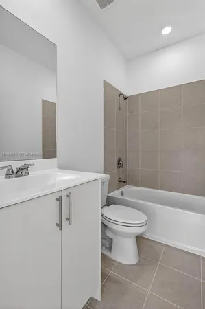 an empty room with sliding door and wooden floor