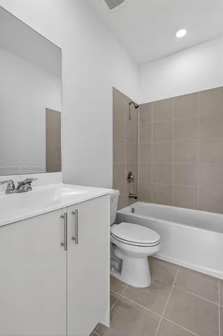 an empty room with sliding door and wooden floor