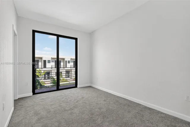 an empty room with sliding door and mountain view