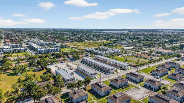 an aerial view of residential houses with outdoor space