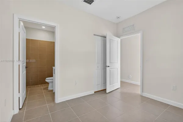 a spacious bathroom with a toilet and a shower
