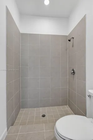 a bathroom with a toilet and shower