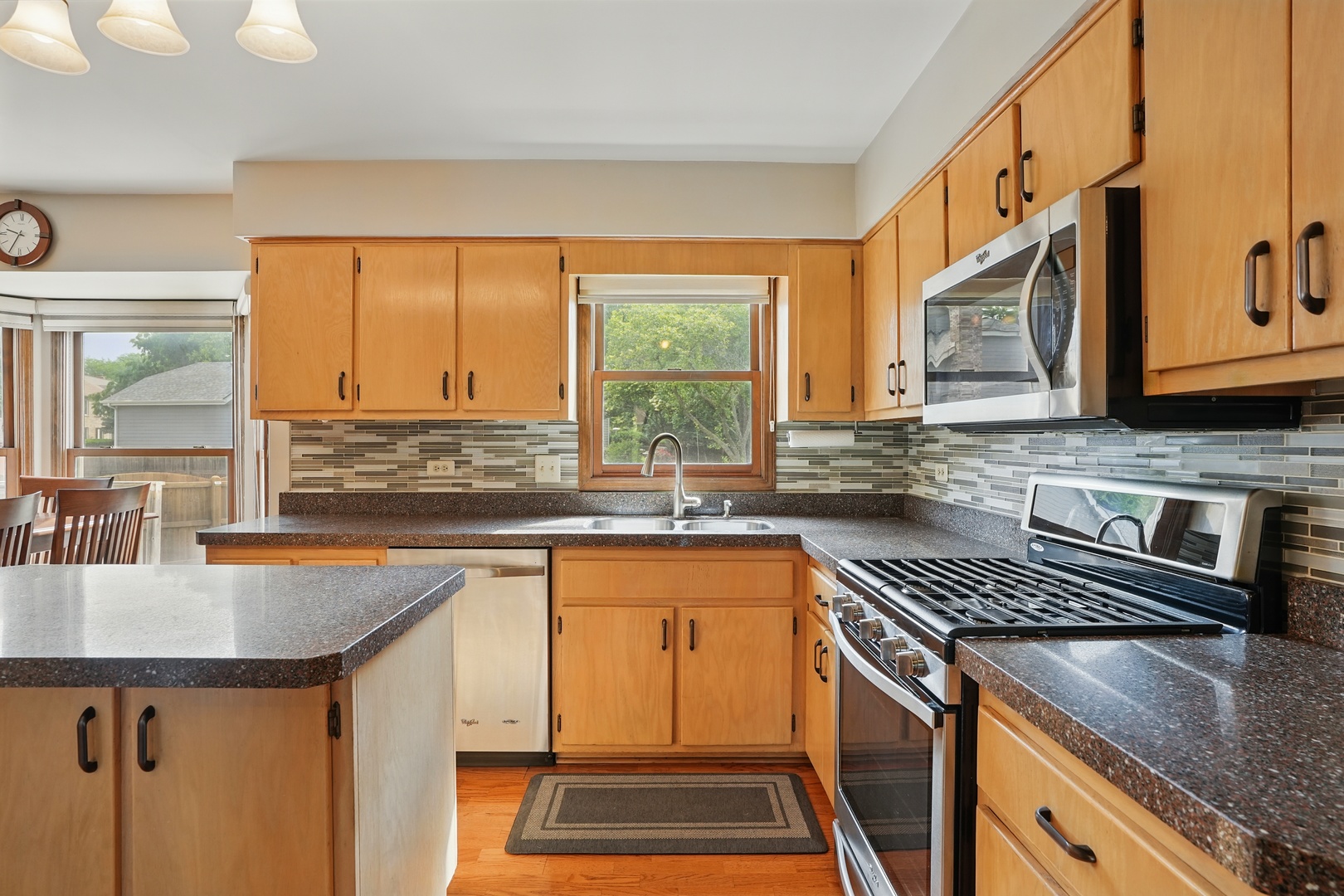 1844 Slippery Rock Road Naperville, IL 60565 - Photo 5 of 39 a kitchen with stainless steel appliances granite countertop a sink stove and cabinets