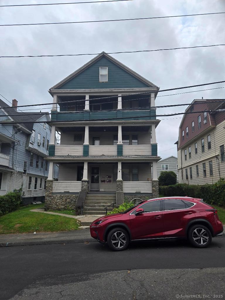 a front view of a house with parking space