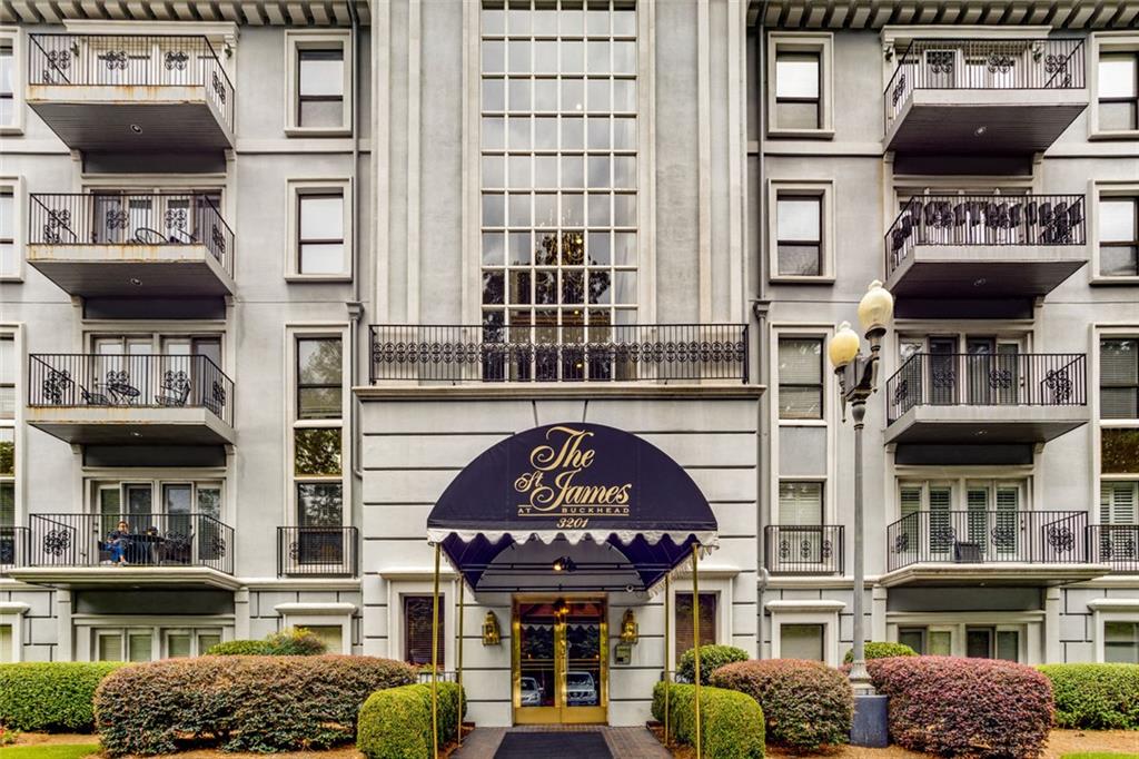 a front view of a building with parking space and windows