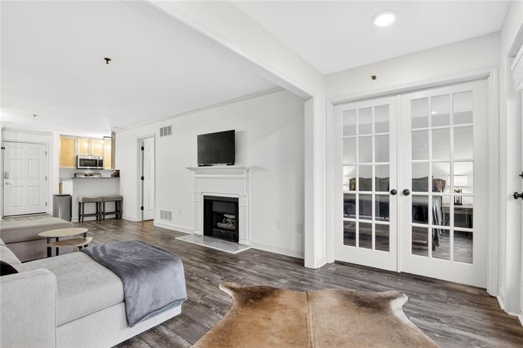 3203 Lenox Road Northeast, Unit 32 Atlanta, GA 30324 - Photo 11 of 38 a spacious bedroom with a balcony a bed and a fireplace