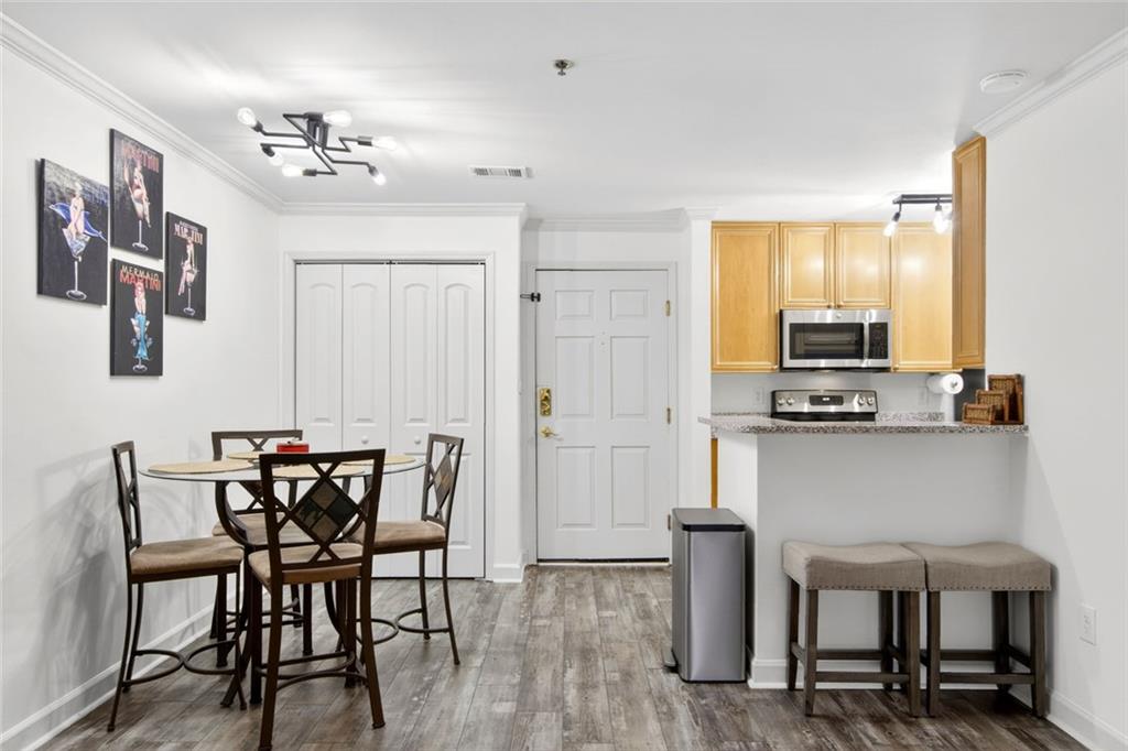 3203 Lenox Road Northeast, Unit 32 Atlanta, GA 30324 - Photo 13 of 38 a view of a dining room with furniture and wooden floor