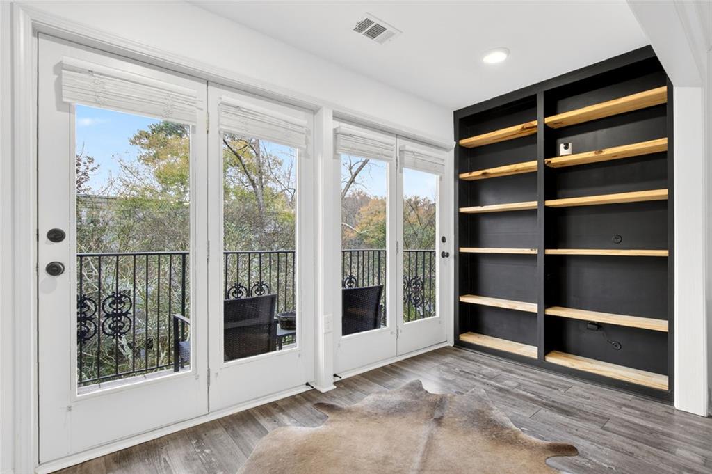 3203 Lenox Road Northeast, Unit 32 Atlanta, GA 30324 - Photo 30 of 38 a view of an empty room with wooden floor and a window
