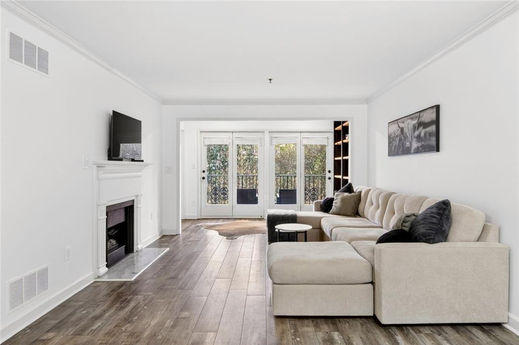 3203 Lenox Road Northeast, Unit 32 Atlanta, GA 30324 - Photo 5 of 38 a living room with furniture a fireplace and a flat screen tv