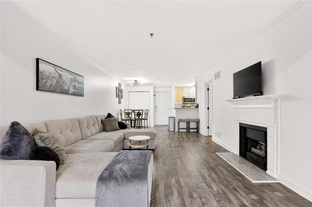 3203 Lenox Road Northeast, Unit 32 Atlanta, GA 30324 - Photo 9 of 38 a living room with furniture a fireplace and a flat screen tv