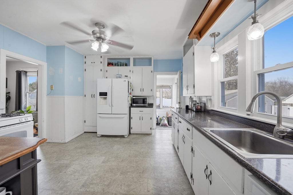 59 Woodmont Street West Springfield, MA 01089 - Photo 15 of 30 a large white kitchen with cabinets and chandelier