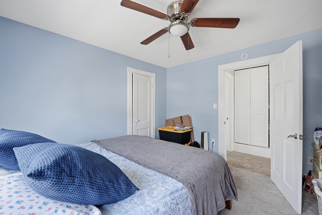 59 Woodmont Street West Springfield, MA 01089 - Photo 18 of 30 a bedroom with a bed and a chandelier