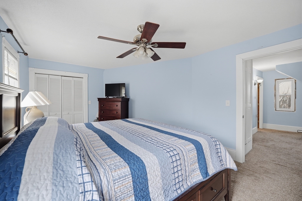 59 Woodmont Street West Springfield, MA 01089 - Photo 20 of 30 a bedroom with a bed and a chandelier