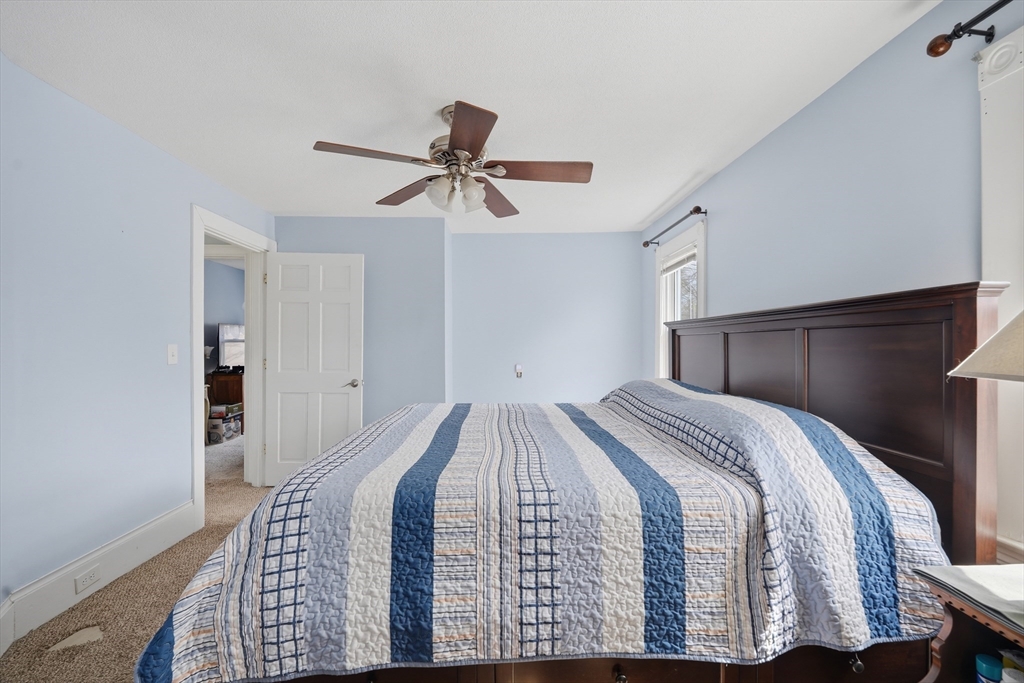 59 Woodmont Street West Springfield, MA 01089 - Photo 21 of 30 a bedroom with a bed and a chandelier