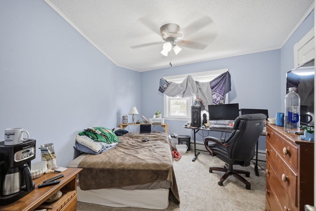 59 Woodmont Street West Springfield, MA 01089 - Photo 22 of 30 a bedroom with a bed and a chandelier