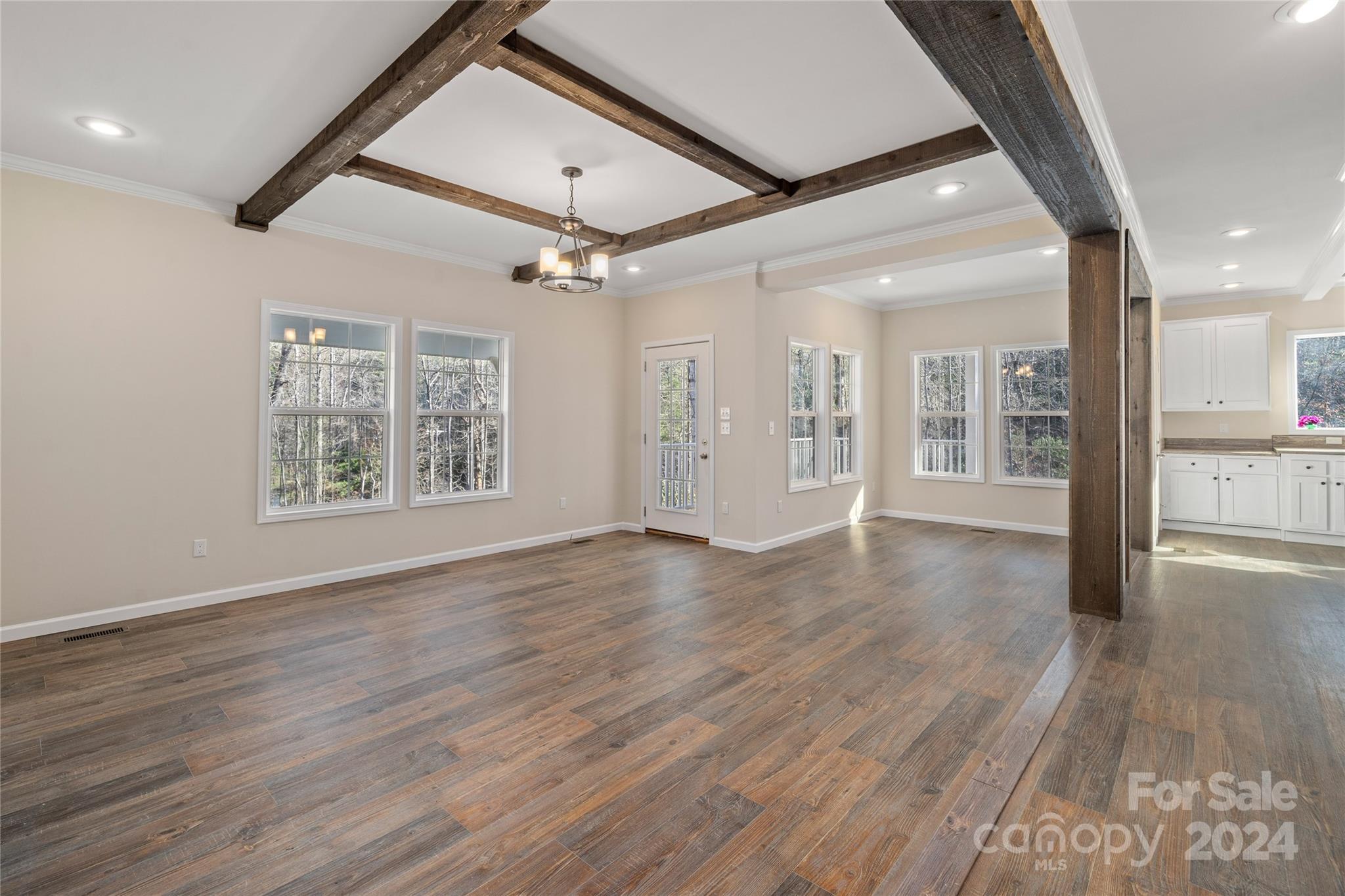 493 Patterson Road Hendersonville, NC 28739 - Photo 26 of 37 an empty room with wooden floor ceiling fan and windows