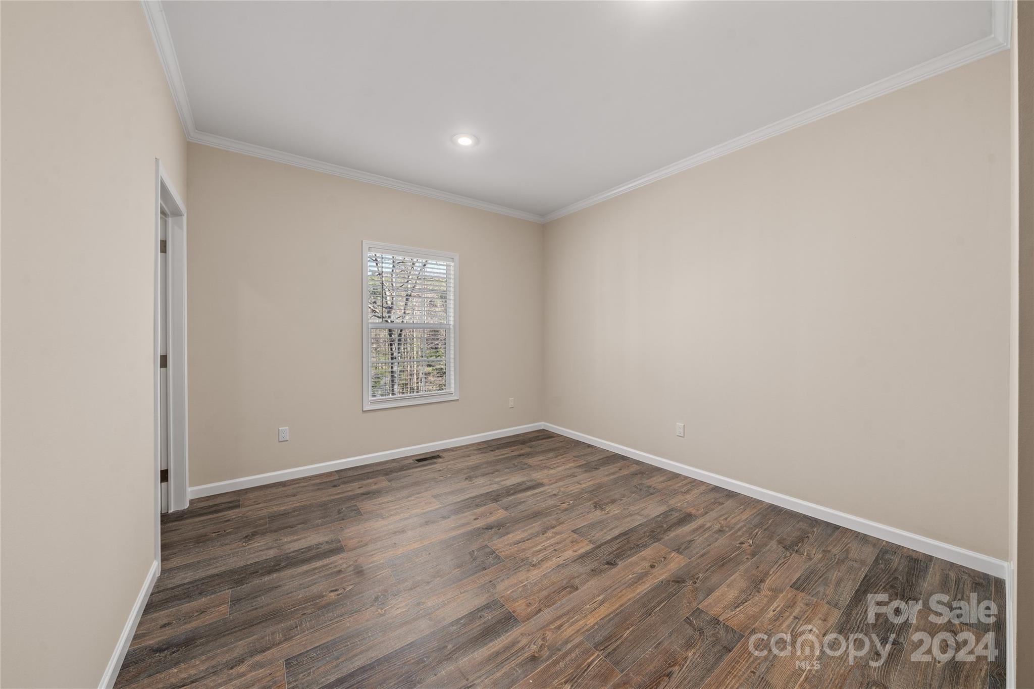 493 Patterson Road Hendersonville, NC 28739 - Photo 28 of 37 a view of an empty room with wooden floor and a window