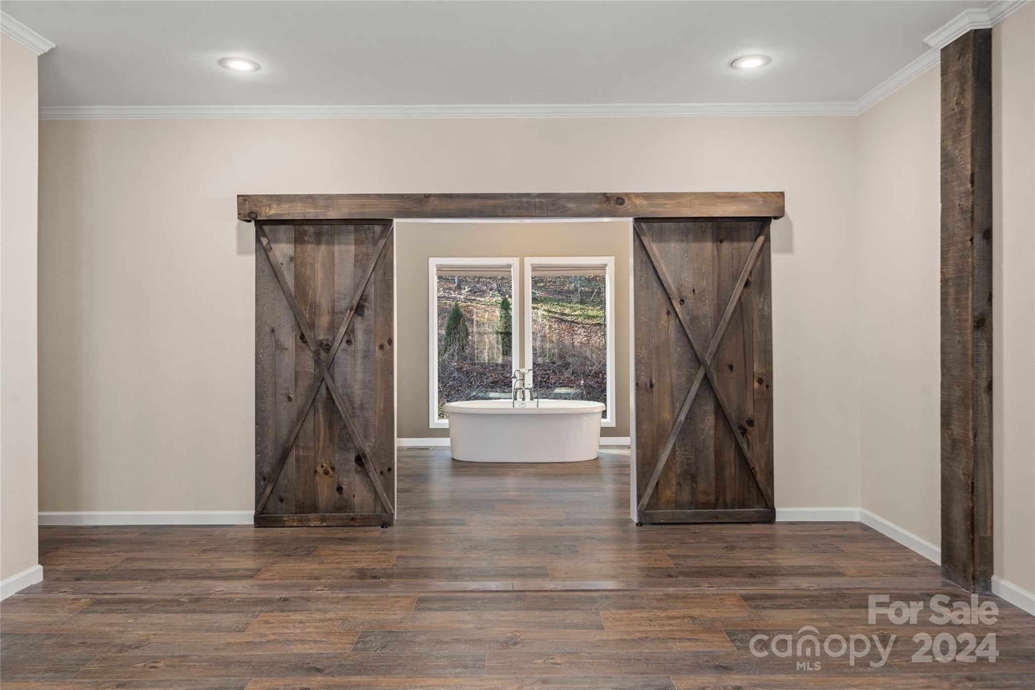 493 Patterson Road Hendersonville, NC 28739 - Photo 29 of 37 an empty room with wooden floor and a fireplace