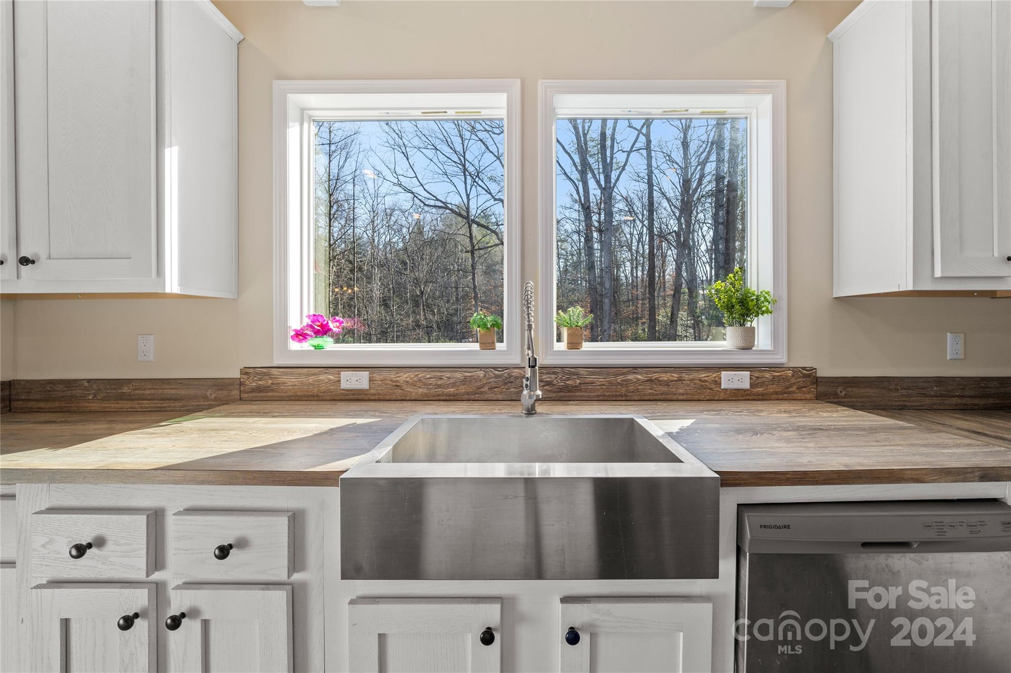 493 Patterson Road Hendersonville, NC 28739 - Photo 3 of 37 a kitchen with a sink and a large window