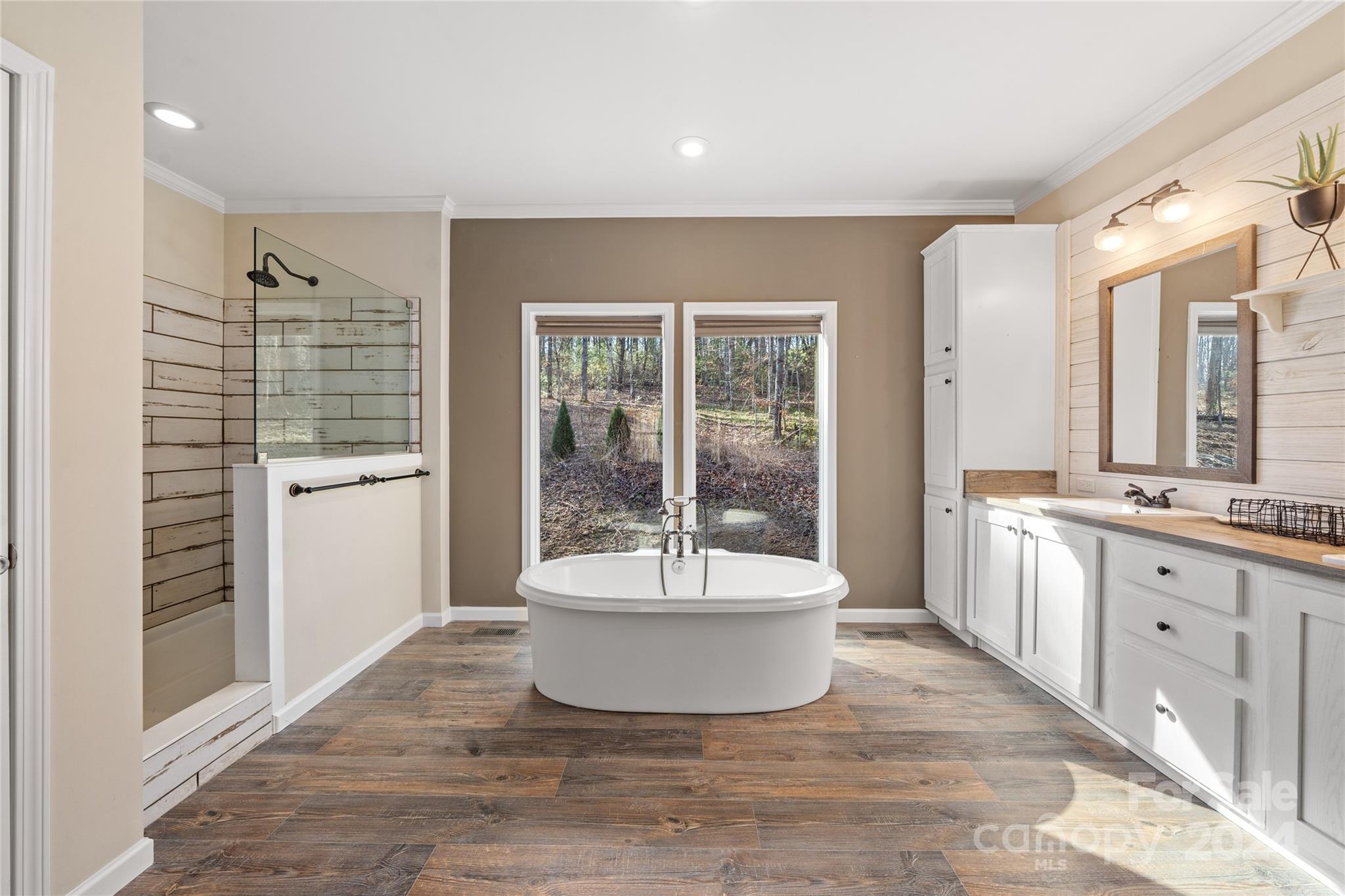 493 Patterson Road Hendersonville, NC 28739 - Photo 31 of 37 a spacious bathroom with a granite countertop sink and a bathtub
