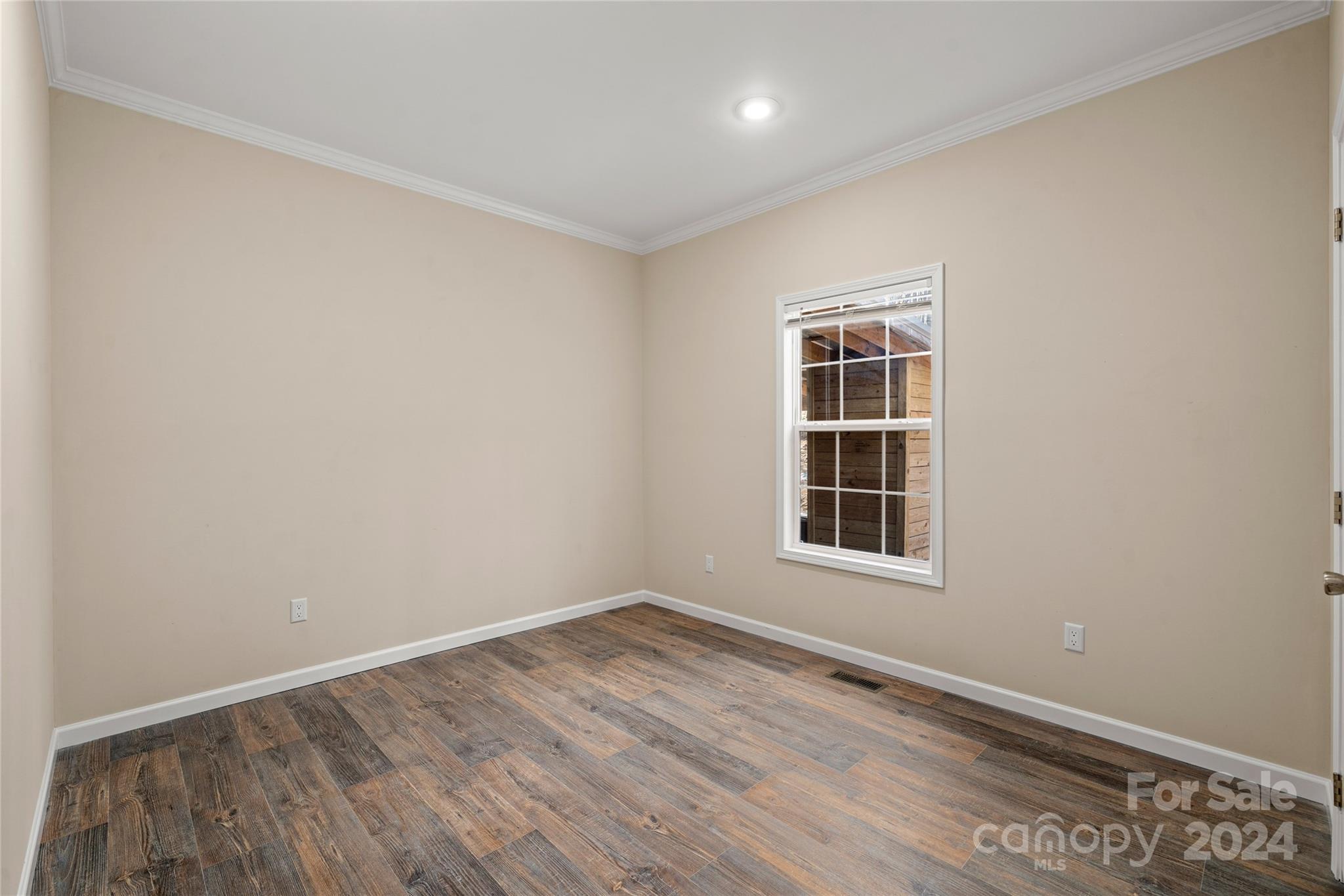 493 Patterson Road Hendersonville, NC 28739 - Photo 35 of 37 a view of an empty room with wooden floor and a window