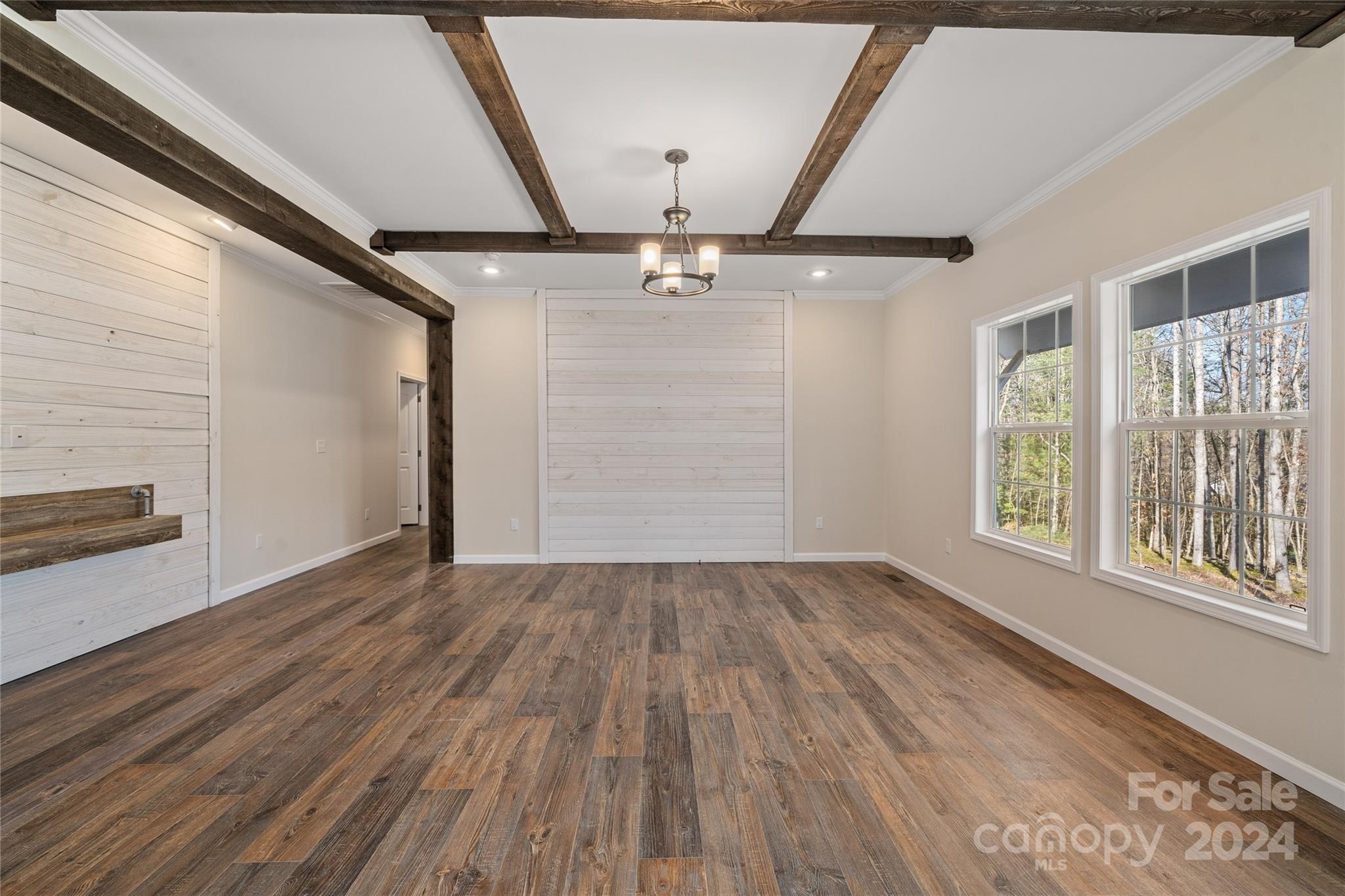 493 Patterson Road Hendersonville, NC 28739 - Photo 4 of 37 a view of an empty room with a window and wooden floor