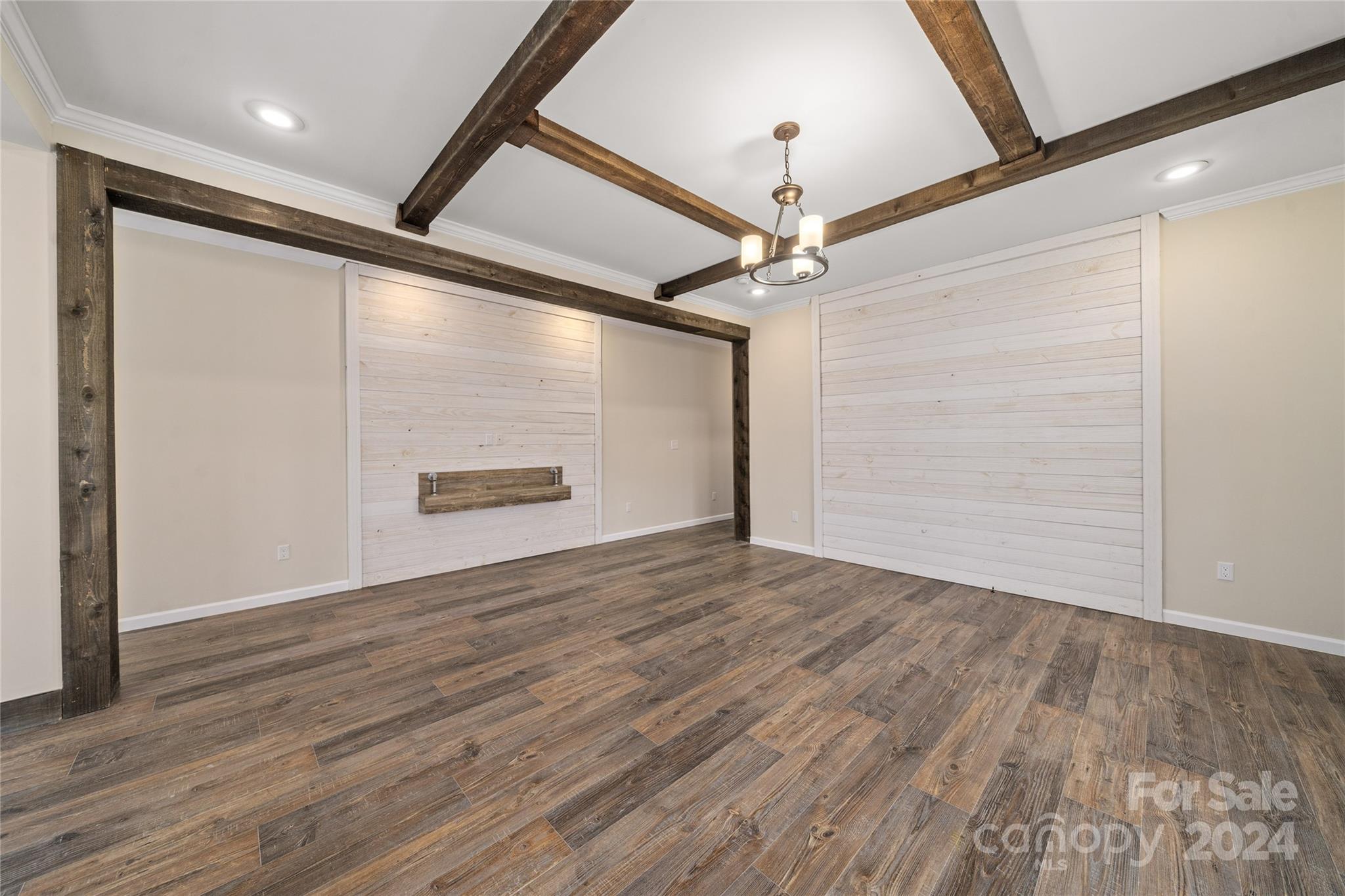 493 Patterson Road Hendersonville, NC 28739 - Photo 5 of 37 a view of an empty room with wooden floor and a ceiling fan