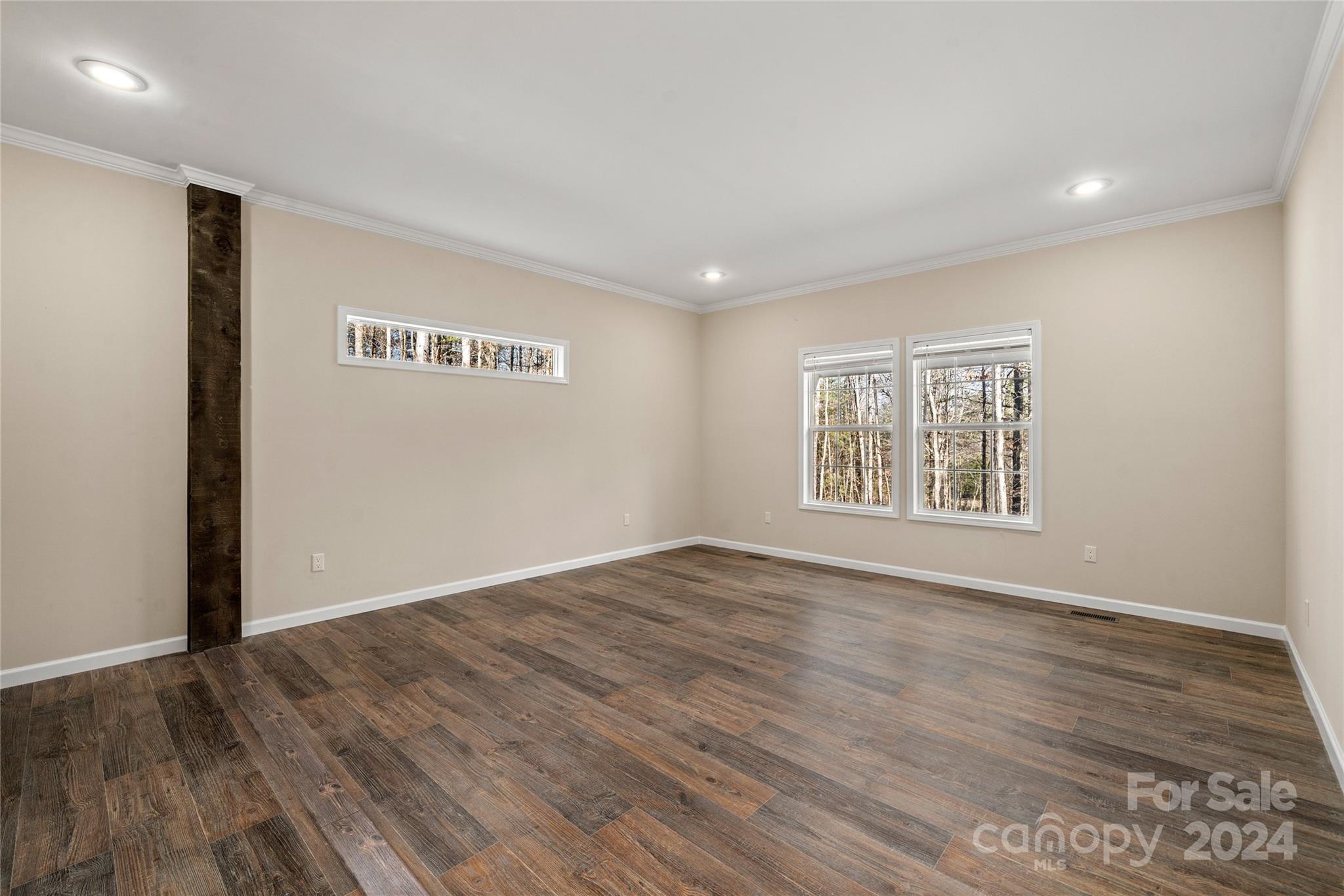 493 Patterson Road Hendersonville, NC 28739 - Photo 8 of 37 an empty room with wooden floor and windows