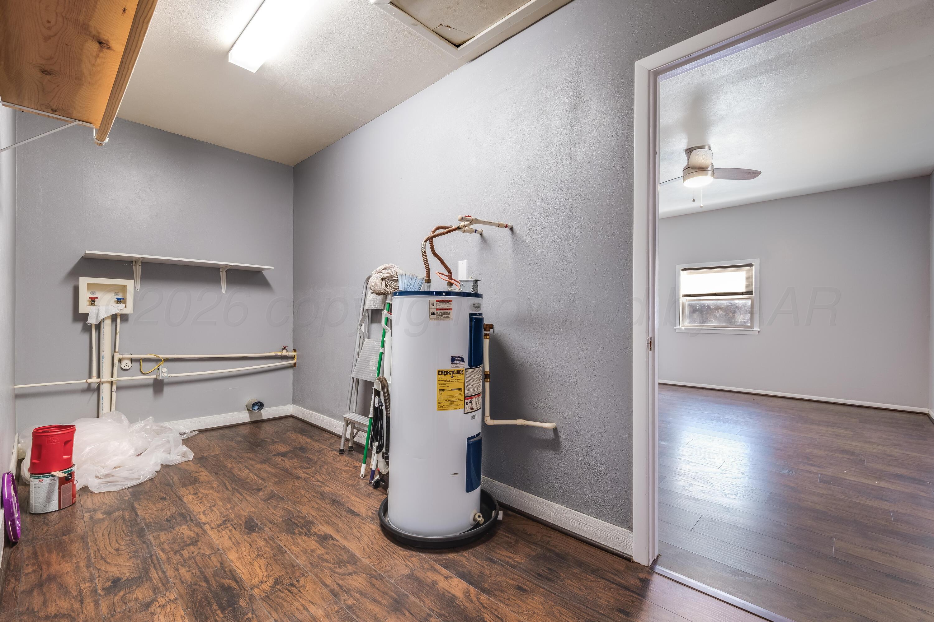 102 Lee Avenue Allison, TX 79011 - Photo 11 of 30 a view of a hallway with wooden floor and dining room view
