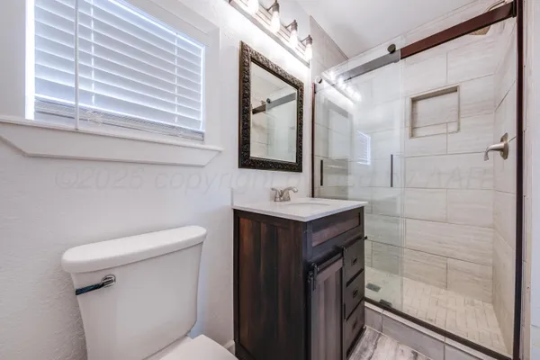 a bathroom with a sink a toilet and mirror