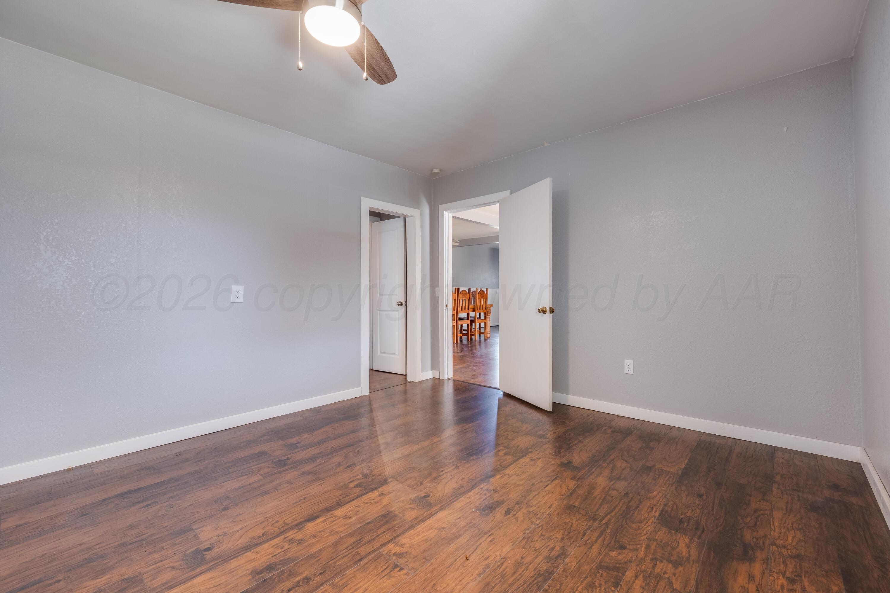 102 Lee Avenue Allison, TX 79011 - Photo 18 of 30 wooden floor in an empty room with a window