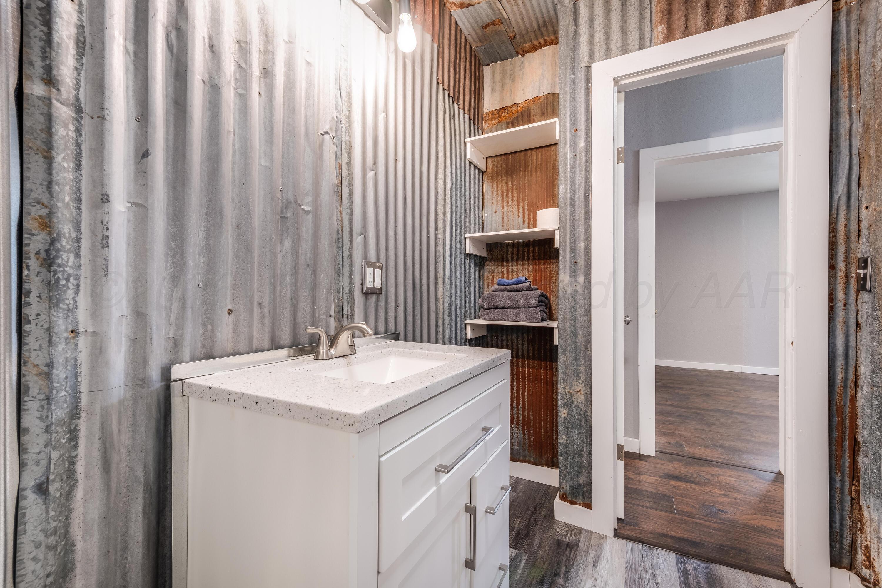102 Lee Avenue Allison, TX 79011 - Photo 20 of 30 a bathroom with a sink and a mirror