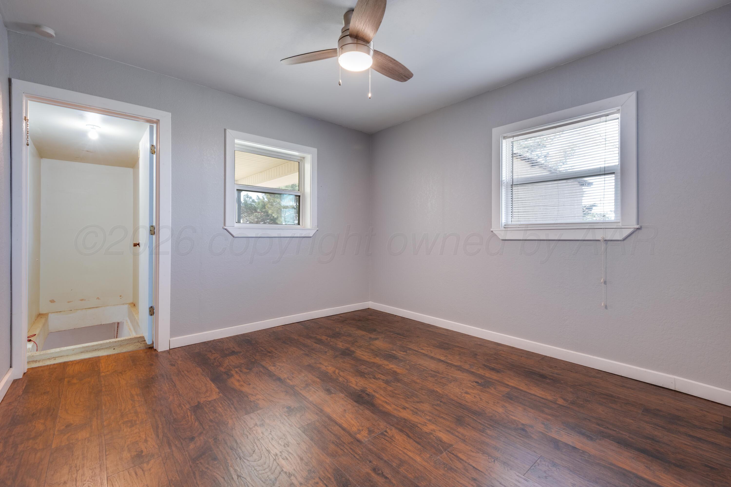 102 Lee Avenue Allison, TX 79011 - Photo 21 of 30 wooden floor in an empty room with a window