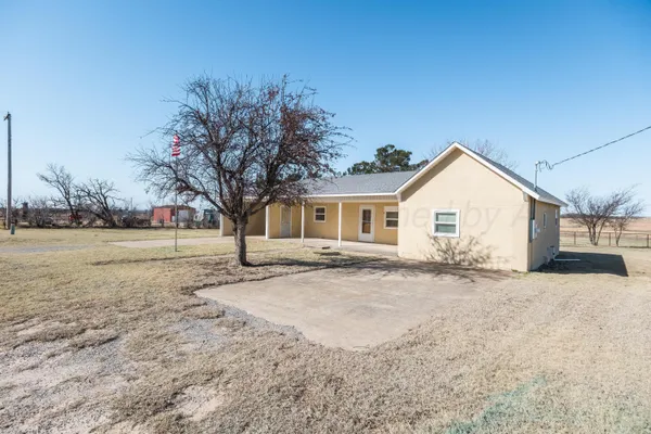 a view of a house with a yard covered with snow