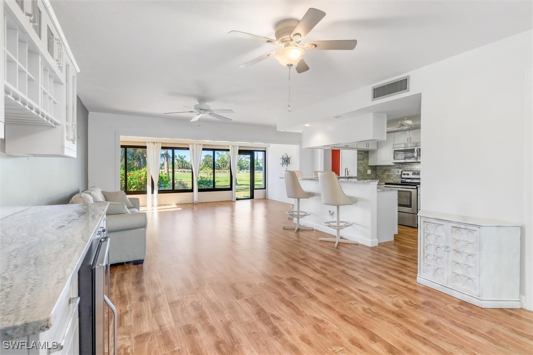 5625 Trailwinds Drive, Unit 412 Fort Myers, FL 33907 - Photo 15 of 40 a living room with furniture and a large window