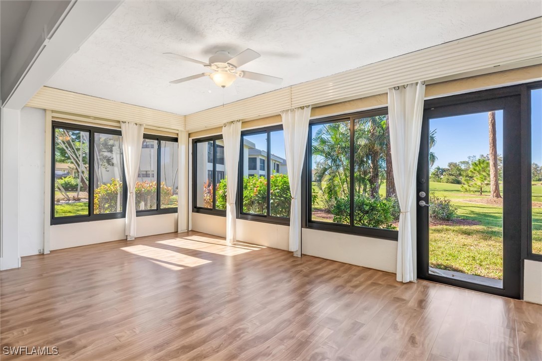 5625 Trailwinds Drive, Unit 412 Fort Myers, FL 33907 - Photo 2 of 40 a view of an empty room with wooden floor and a window