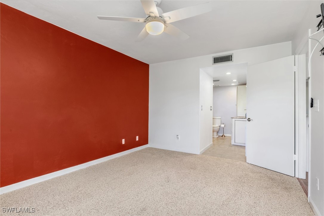 5625 Trailwinds Drive, Unit 412 Fort Myers, FL 33907 - Photo 21 of 40 an empty room with closet and a chandelier fan