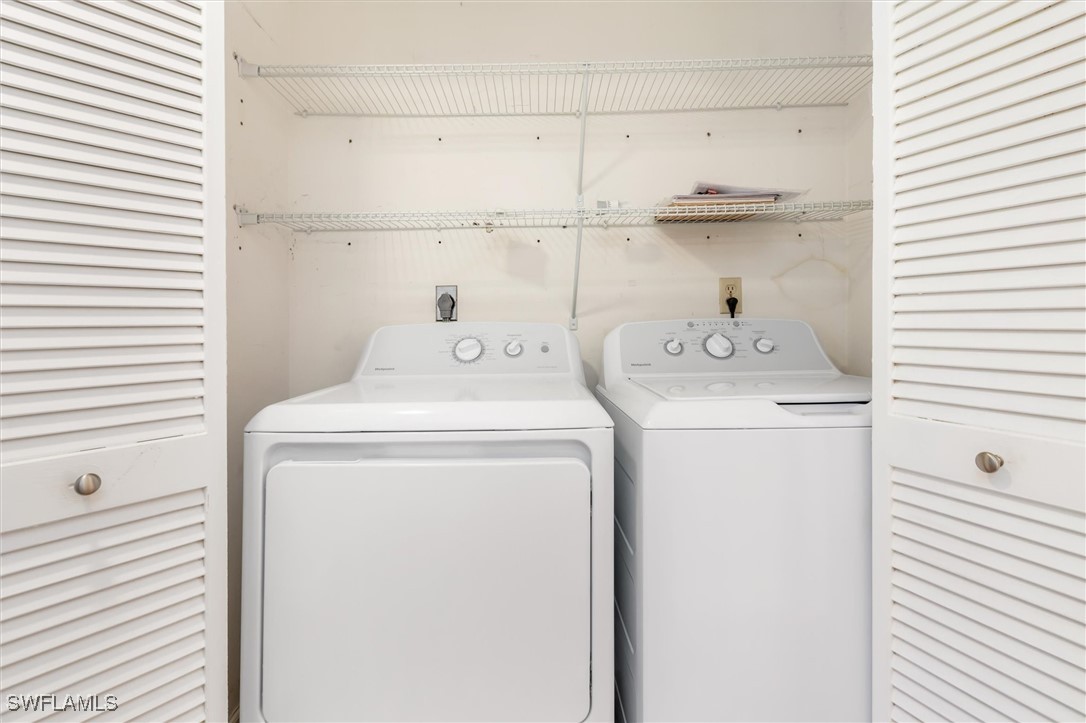 5625 Trailwinds Drive, Unit 412 Fort Myers, FL 33907 - Photo 23 of 40 a utility room with dryer and washer