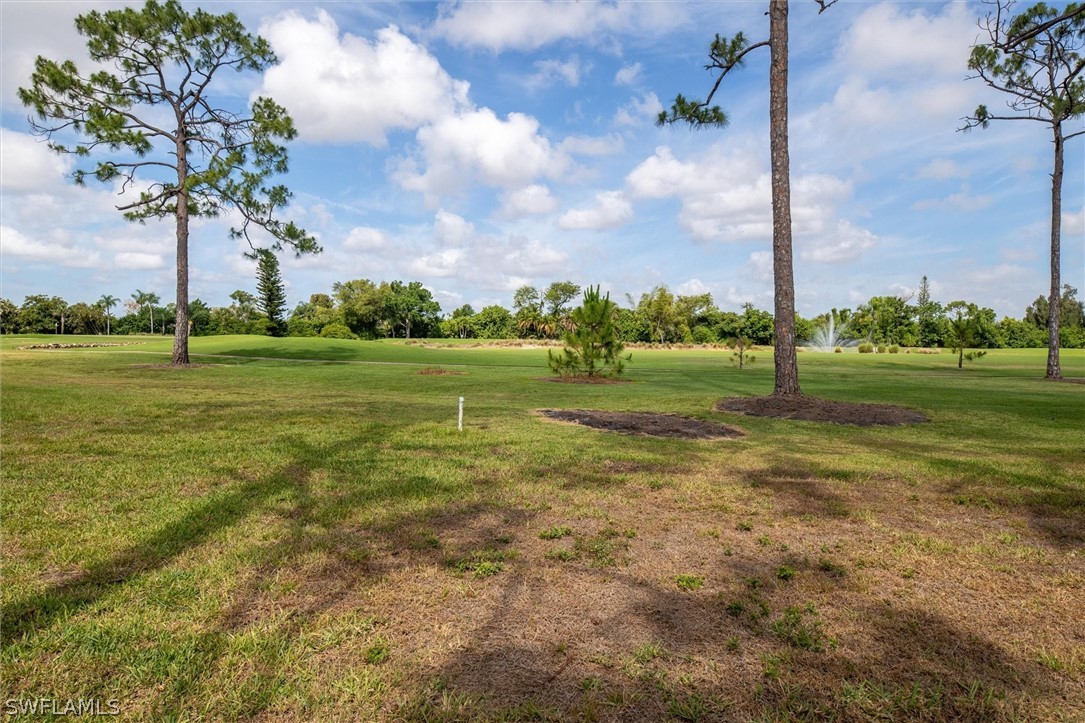 5625 Trailwinds Drive, Unit 412 Fort Myers, FL 33907 - Photo 29 of 40 a view of a golf course with a big yard
