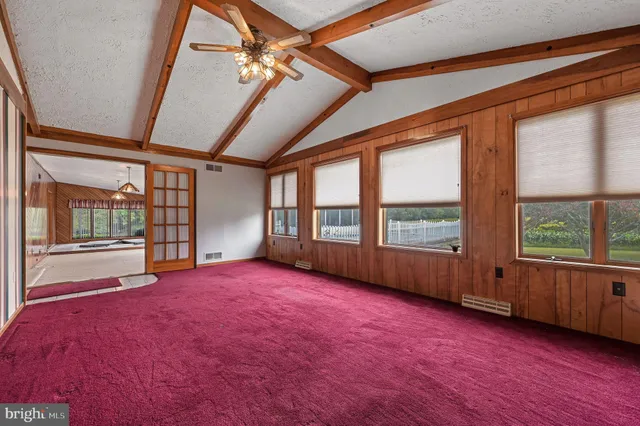 a kitchen with stainless steel appliances granite countertop a refrigerator a sink dishwasher and wooden cabinets with wooden floor