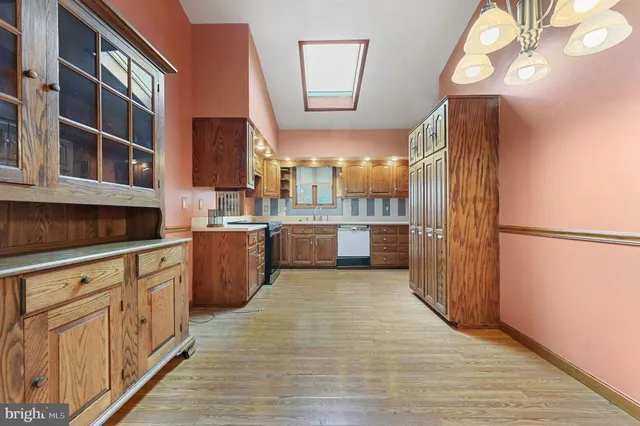 a kitchen with a sink cabinets and wooden floor