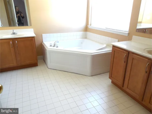 a bathroom with a bathtub and a sink